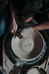 Matthew at the pottery wheel, centering a plate